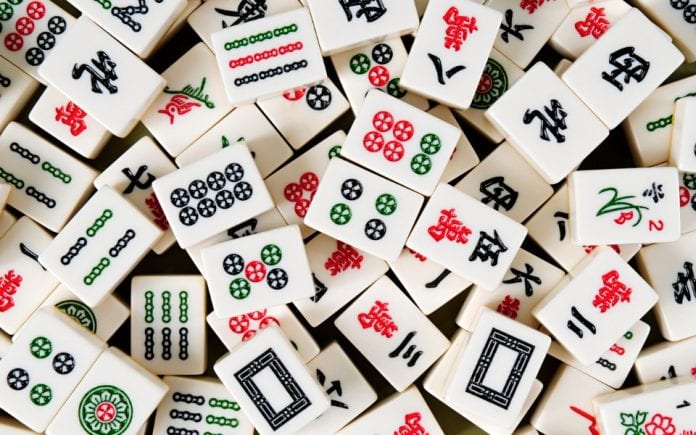 Chinese mahjong card thrown on a table face up showing symbols